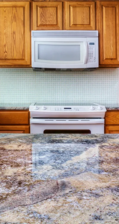 Granite counter reflecting kitchen cabinets