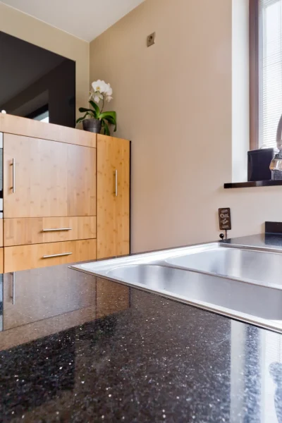 A modern kitchen with black granite tabletop